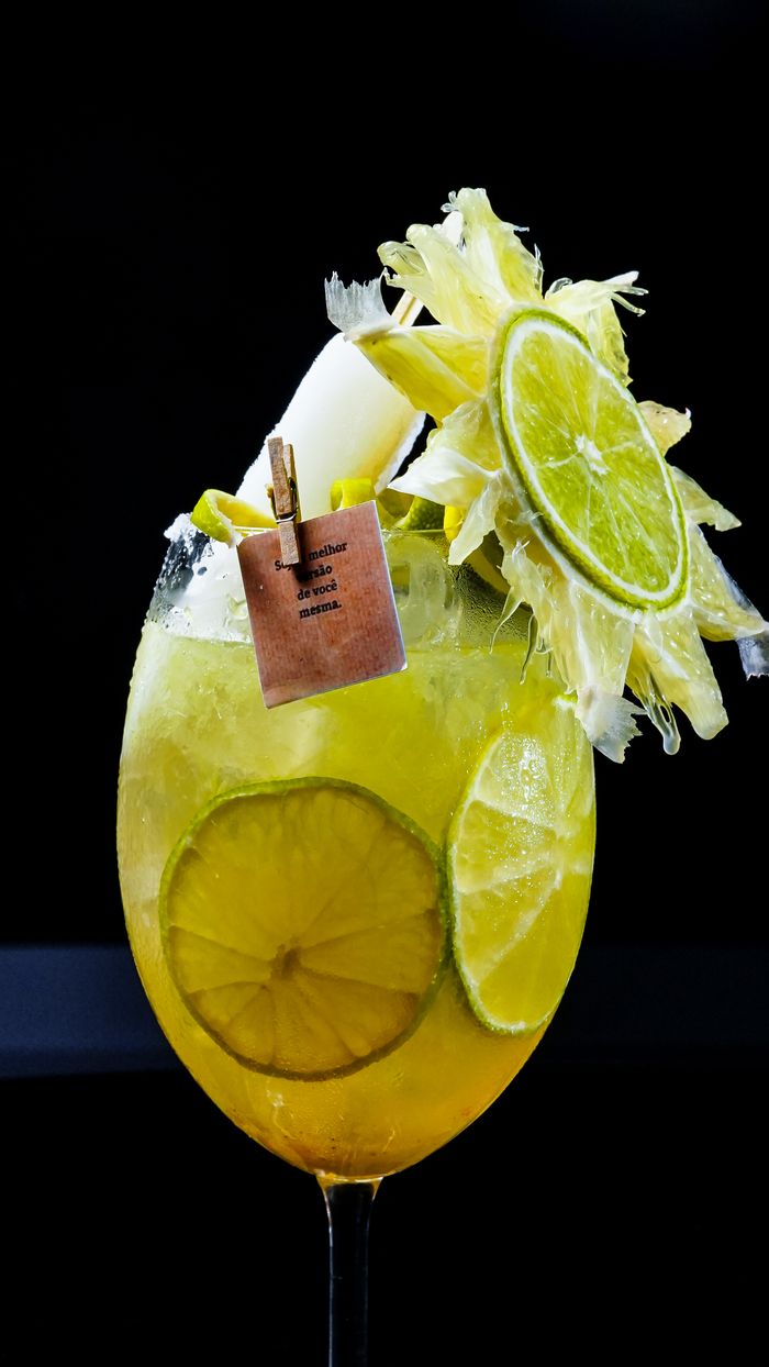 Home Vibrant tropical cocktail adorned with lime slices and a pineapple garnish for a refreshing experience.